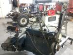 engine on hoist frame in background